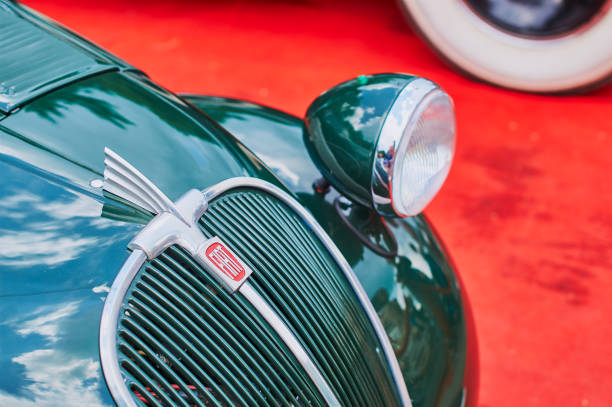 Closeup of old vintage green Fiat 500 Topolino car on red background Lviv, Ukraine, June 5, 2016: Closeup of old vintage green Fiat 500 Topolino car released circa 1939 in Turin, Italy fiat 500 topolino stock pictures, royalty-free photos & images
