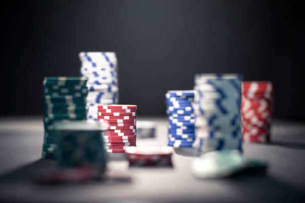 istock Casino poker chips in dramatic dark shadow or at night in spotlight. Stack of game money. Risk, luck and betting concept. 1174418561