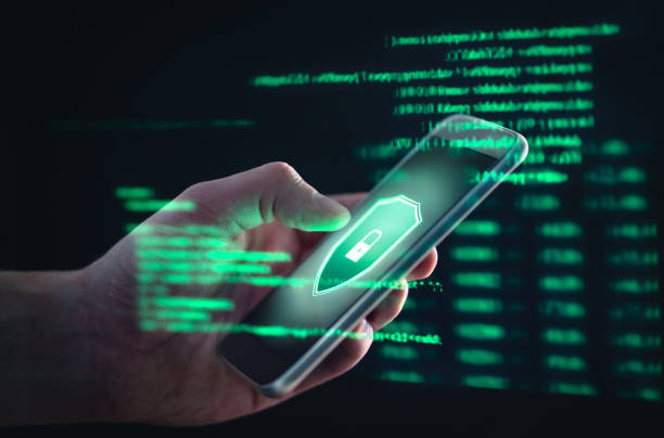 istock Phishing, cyber security, online information breach or identity theft crime concept. Hacked phone. Hacker and cellphone with hologram data. Mobile scam, fraud or crime. 1174418652