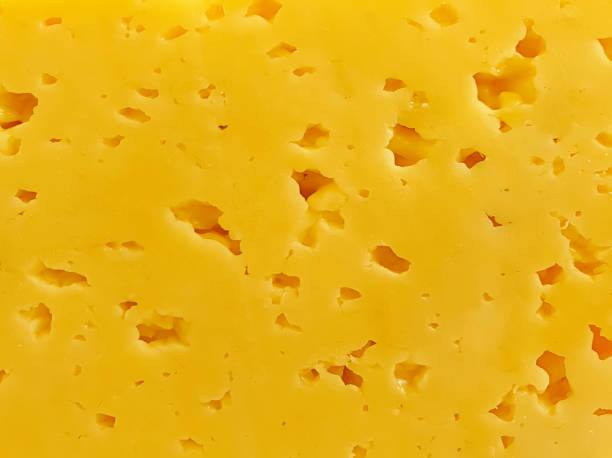 istock yellow fresh tasty cheese background 1174418685