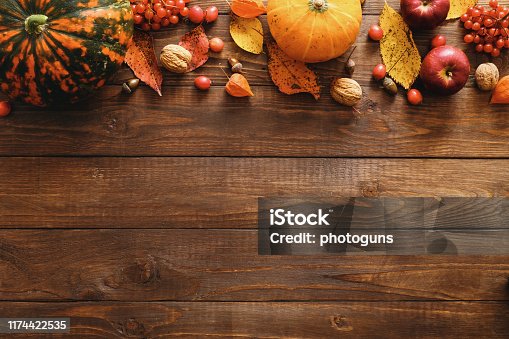 istock Happy Thanksgiving concept. Autumn composition with ripe orange pumpkins, fallen leaves, dry flowers on rustic wooden table. Flat lay, top view, copy space. 1174422535