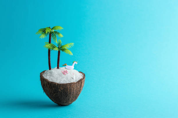 istock Tropical beach concept made of coconut and palm tree on blue background. Creative minimal summer idea. 1174422852