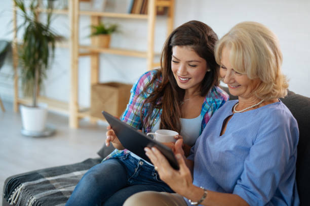 istock Senior mother and daughter browsing internet on tablet 1174424155