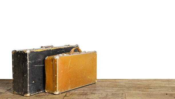 istock Old suitcases on wooden floor isolated on white 1174424386