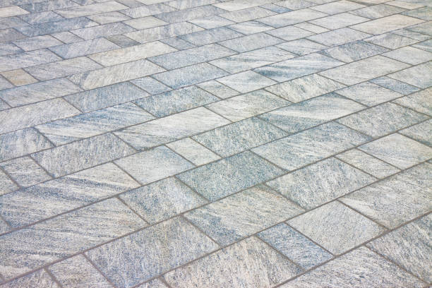 new paving made with stone blocks of rectangular shape in a pedestrian zone - concrete driveway cement construction imagens e fotografias de stock