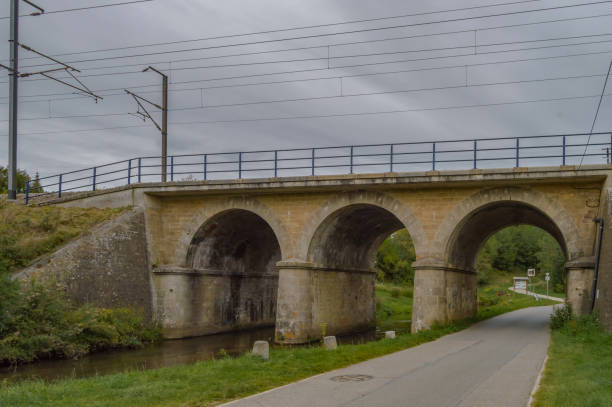 istock Railway bridge with three arches, two for the river of the tone 1174427100