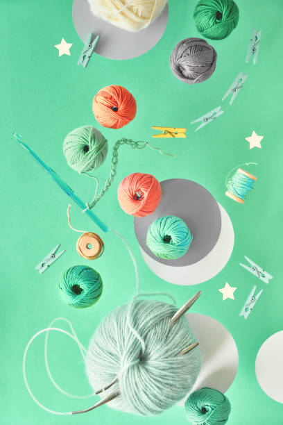 istock Various wool yarn and knitting needles, creative knitting hobby background on neo mint color 1174427197