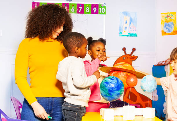 istock Group of kids in kindergarten play learn planet 1174427448