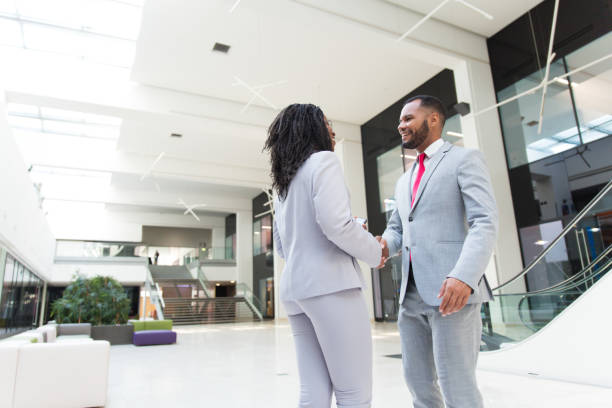 istock Business people welcoming each other in office hallway 1174427464