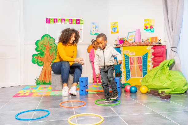 istock Black boy jumps on circles in kindergarden 1174427477