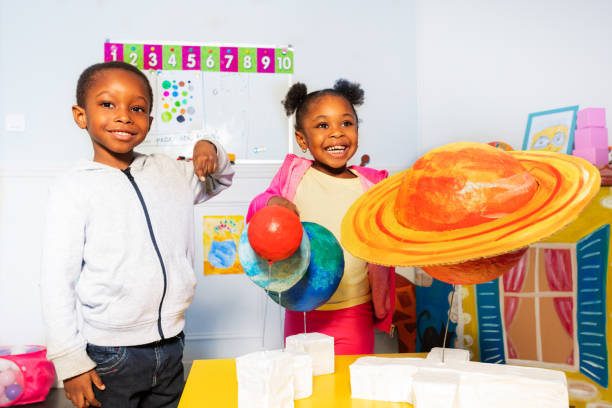 istock Group of kids play with solar system planets 1174427527