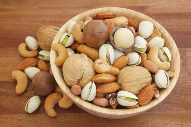 istock Many mixed nuts in wooden bowl 1174430930