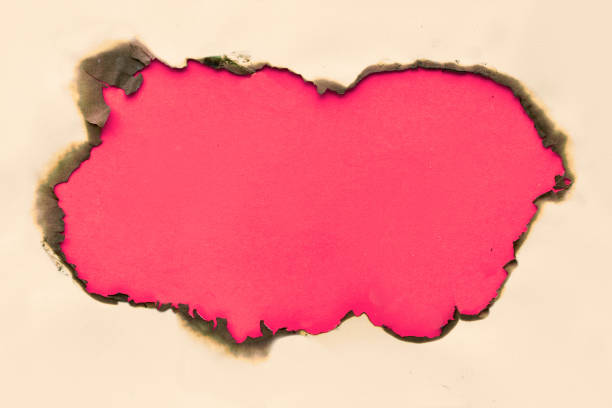 istock Vibrant color paper background with burnt hole in the middle 1174433165