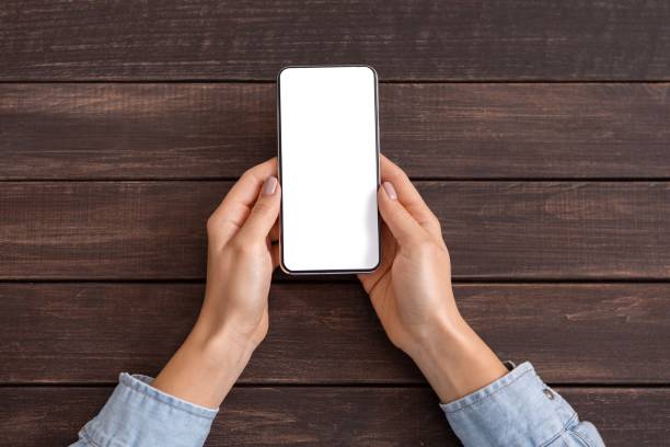 istock Woman hands holding modern smartphone with blank screen for mockup 1174433735