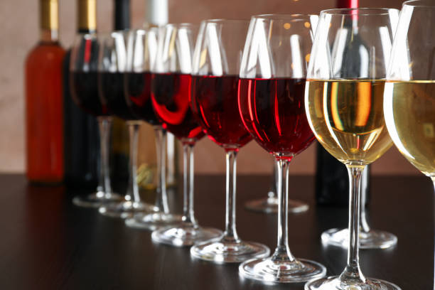 istock Bottles and glasses with wine on dark table, blurred lights, closeup 1174434648