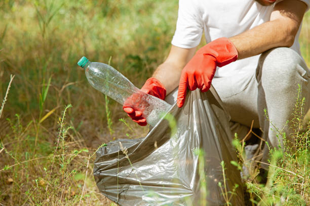 istock Volunteer tidying up rubbish on beach 1174435465