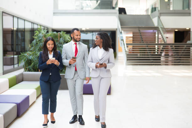 istock Happy business colleagues using mobile phones 1174435506