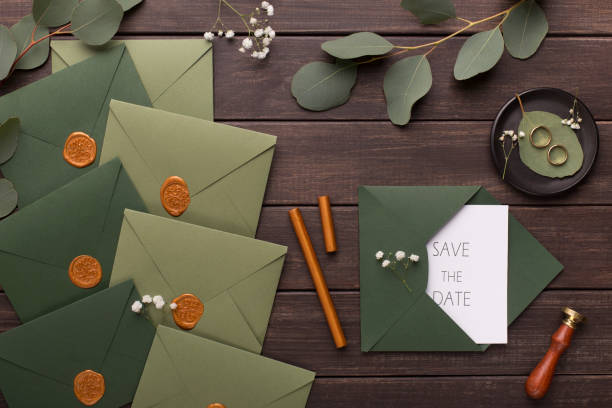 istock Wedding invitations save the date in green envelopes 1174435544