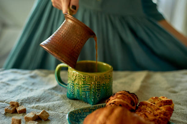istock A woman's hand pours coffee brewed in Turk.Rustic simplicity 1174435635