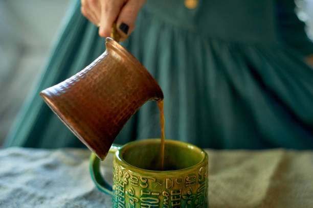 istock A woman's hand pours coffee brewed in Turk.Rustic simplicity 1174435731