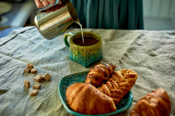 istock Female hand pours milk into coffee.Rustic simplicity 1174435798