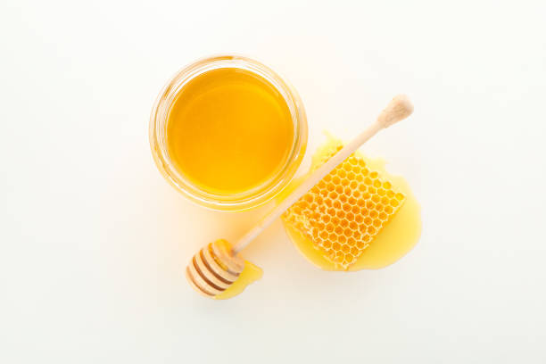 istock Glass jar, honeycomb and dipper isolated on white background 1174436694