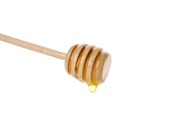 istock Dipper with honey isolated on white background, close up 1174437122