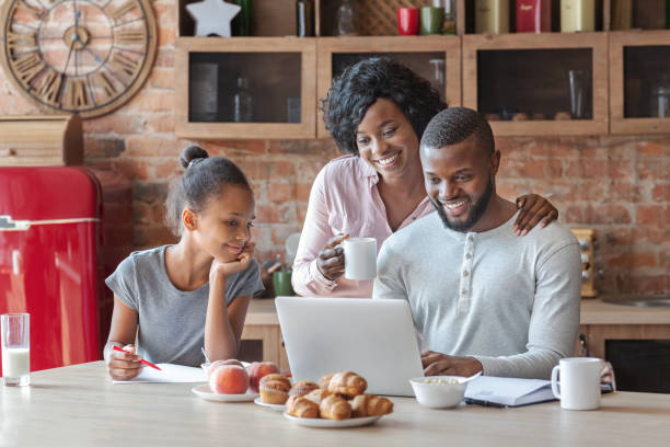istock Happy black family looking for recipe on internet 1174437149