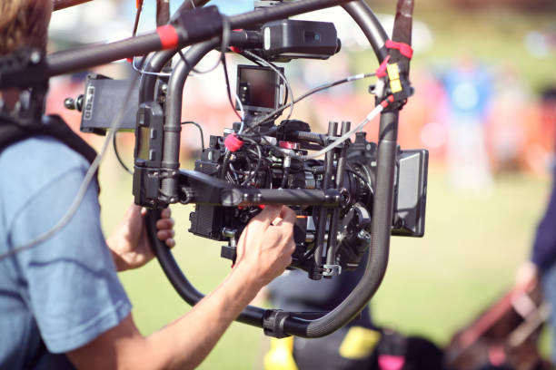 istock Video camera operator shooting outside news event 1174437168