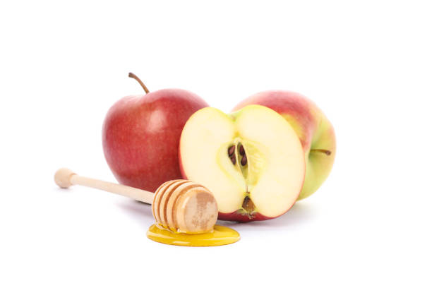 istock Apples and dipper with honey isolated on white background 1174437238