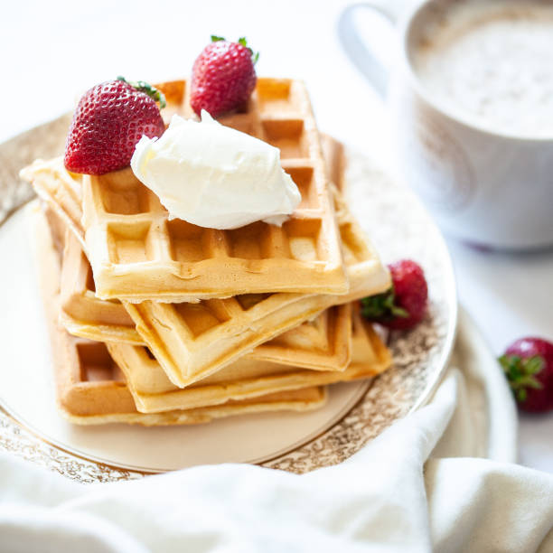istock Waffles with ice cream, strawberries and coffee 1174437342