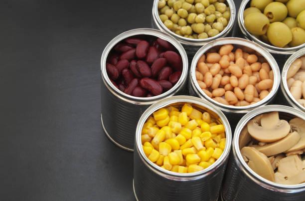istock Canned food on black table background 1174438231