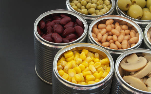 istock Canned food on black table background 1174438440