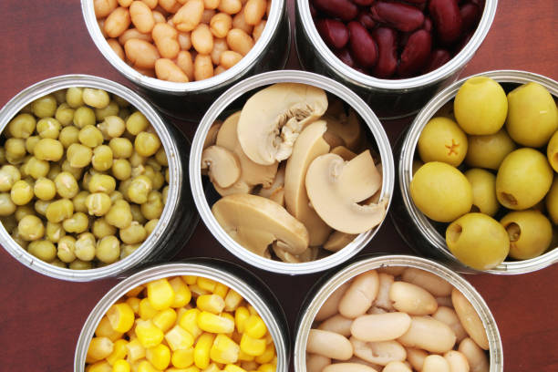 istock Canned food on wooden background 1174438536