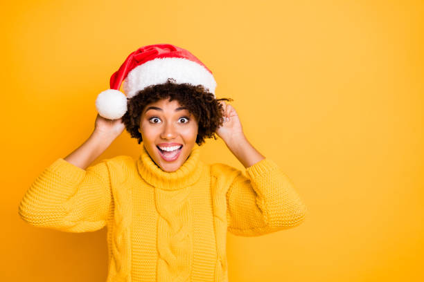 Its my size. Close up photo of glad optimistic lucky rejoicing overjoyed girl trying to wear hat on head and curly wavy hairstyle isolated bright color background Its my size. Close up photo of glad optimistic lucky rejoicing overjoyed girl trying to wear hat on head and curly wavy hairstyle isolated, bright color background christmas excitement stock pictures, royalty-free photos & images