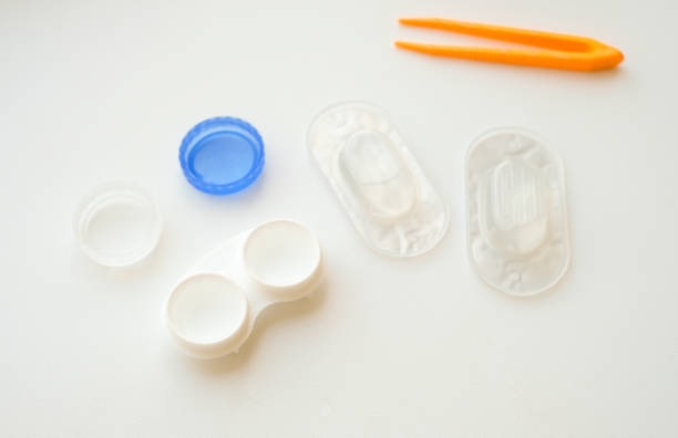 istock Accessories for use of contact lenses: case, tweezers, blister pack and solution on white background. Safe vision correction. View from above. 1174438906