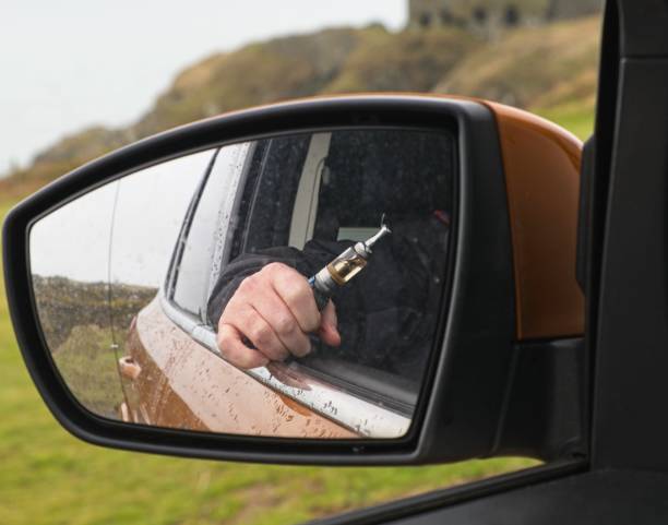 istock Image in the mirror of man vaping 1174439799