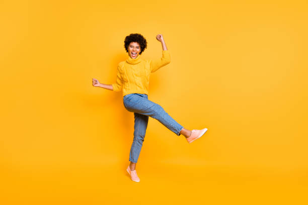 istock Full length body size view of her she nice attractive charming cheerful cheery ecstatic wavy-haired girl celebrating luck having fun isolated on bright vivid shine vibrant yellow color background 1174439972