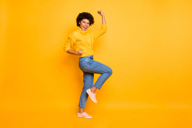 istock Full length body size profile side view of her she nice attractive cheerful cheery ecstatic wavy-haired girl celebrating lucky day isolated on bright vivid shine vibrant yellow color background 1174439997