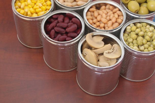 istock Canned food on wooden background 1174440123