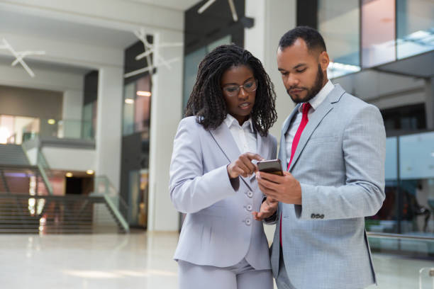 istock Focused business colleagues with smartphone 1174440164