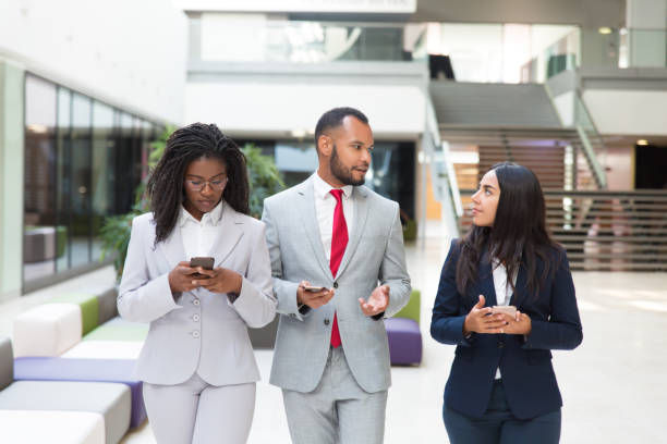 istock Business group with cellphones discussing project 1174440215