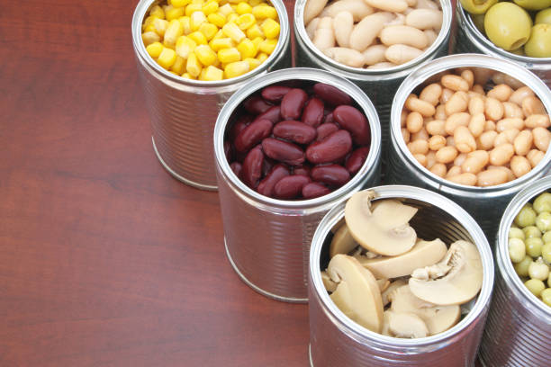 istock Canned food on wooden background 1174440221