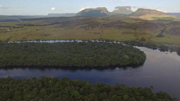 istock Small Tepuis (Flat Top Mountains) standing across a River in Canaima, Venezuela 1174440273