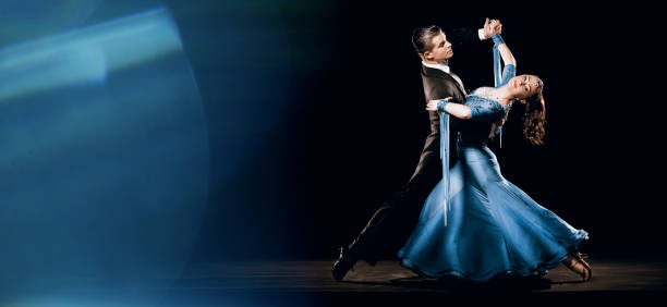 Ballroom Dancing Couple Standard Waltz Oversway Background Dramatic Argentinean Dance Couple Competing in WDSF Championships tango dance stock pictures, royalty-free photos & images