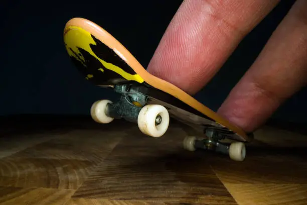 Photo of Fingerboard. A small skateboard for kids and teenagers to play with hand fingers. Youth culture, extreme sport