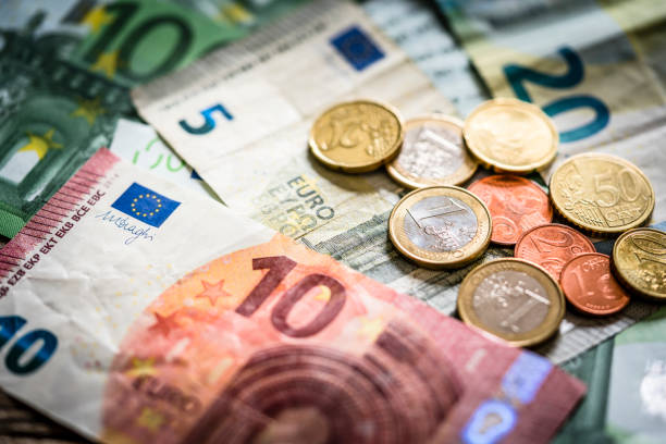 european union banknotes and coins - european union euro note currency forex european union currency imagens e fotografias de stock