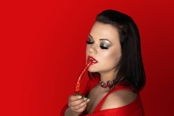 istock woman with red hot pepper 1174444517
