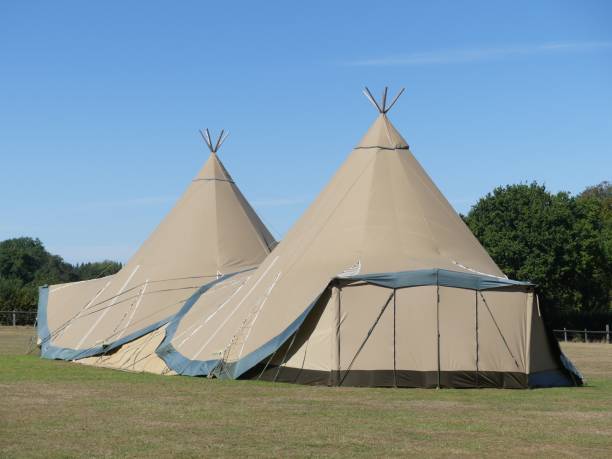 istock Two large tepees set up for event on farmland 1174444750