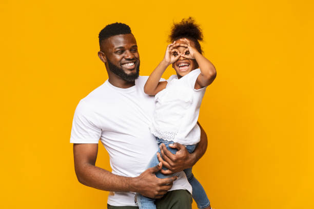 playful little afro girl making finger glasses, fooling on daddy's hands - glasses child cute offspring imagens e fotografias de stock